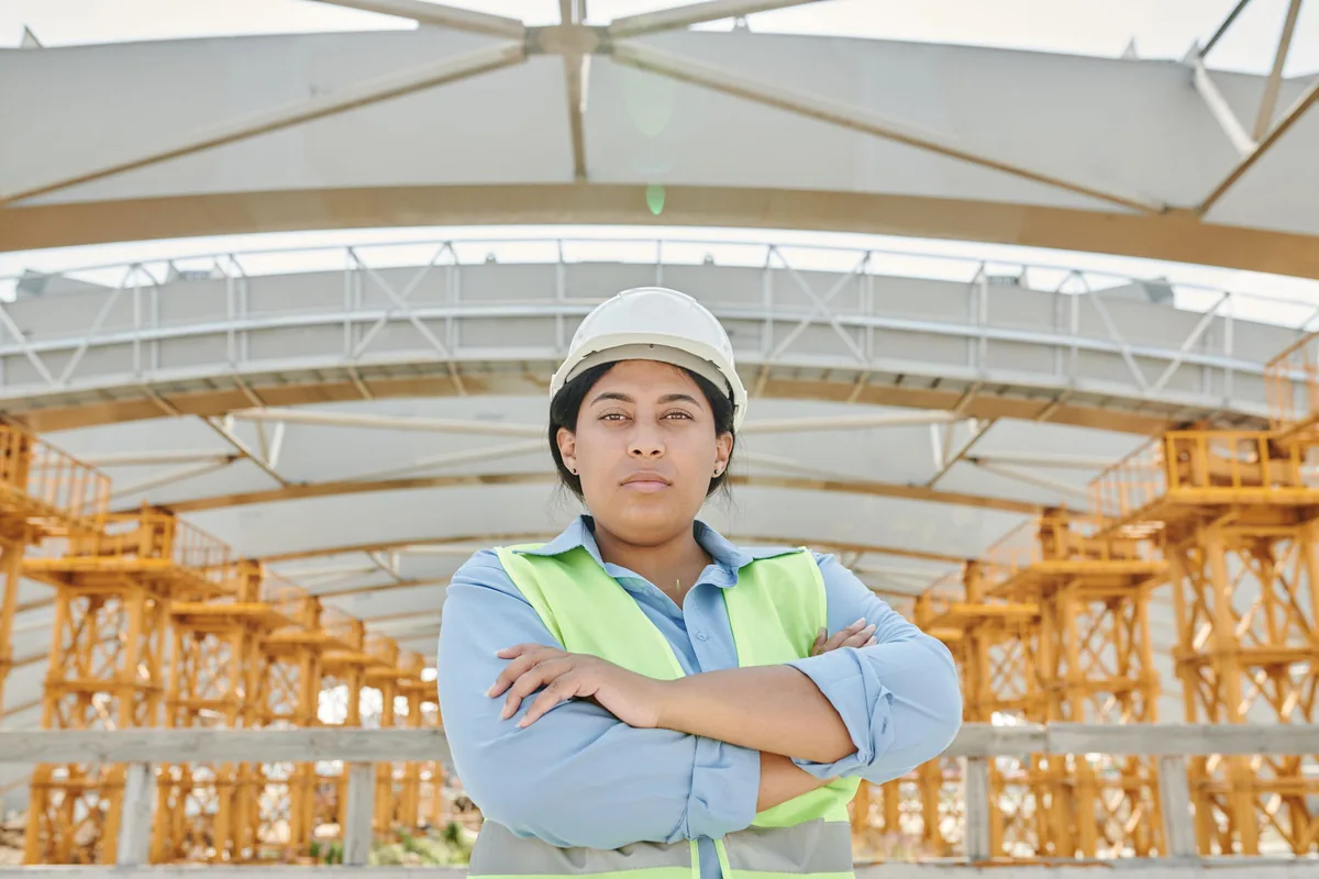 Illustrative stock photo: person wearing a hard hat and safety vest